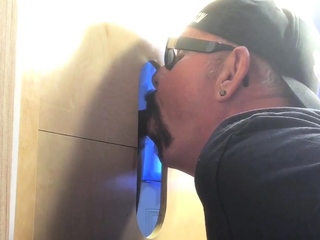 Gloryhole hunk eagerly sucking bbc dick via wall