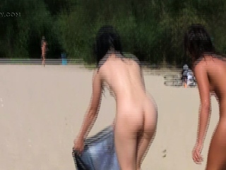 Nude beach girl sunbathes subsequent to her man outdoors