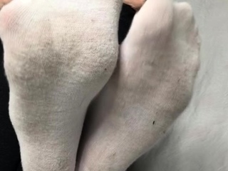 Brunette with foot fetish rubs large dick with her feet in POV