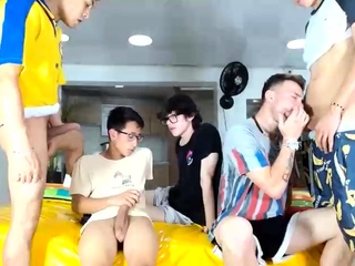 Two randy gay fellas providing blowjobs in group sex action
