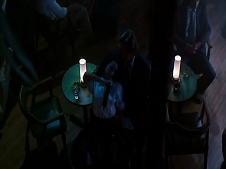 Mia Kirshner dancing for a man at a strip membership, carrying a