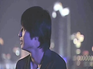 Bai Ling making out with a man as he opens her crimson shirt to