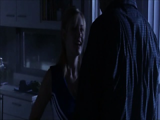 Elisha Cuthbert standing at an ironing board in a blue bra