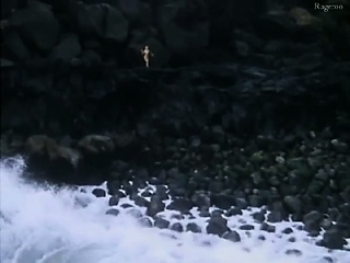 Monique Gabrielle bare seen on a rocky cliff above the
